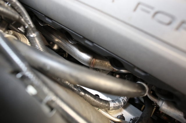 As you can see, the tubes go up and over in order to maximize engine space while clearing the necessary components like the starter and steering shaft on the bottom side.