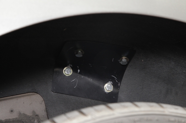 The rear support tube backing plates install in the rear wheel well of the car. The bolts are installed from the wheel well area and tighten into a weld nut on the roll bar support tube.