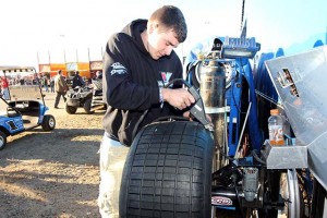 Cody Duncan grooves a tire that will soon find its way on Josh Richard's #1 Rocket Car. Grooves are wider than sipes and help create edges on the tread blocks that "bite" into the track surface.