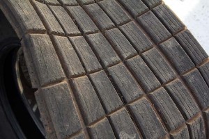 This tire has been cut with minimal grooves across the width of the tire and sipes running only along the radius (called "going with" the tire). This can be helpful to help control heat buildup in an abrasive, high-traction race track without overly stressing the tire.