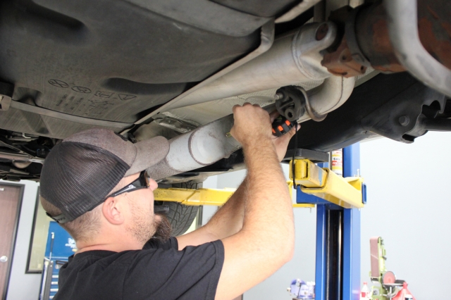 Because we will have to remove the exhaust in two pieces, we have to properly mark where the cut will be made. As per the instructions, Dean makes the mark at 4.25" from the rear face of the muffler.