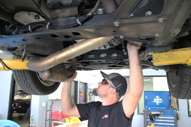 Dean gingerly removes the Y-pipe.