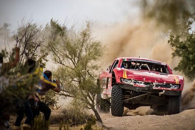 VIDEO: Woman Stands Inches Away From Path Of Trophy Truck