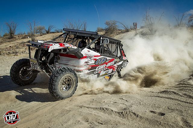 VIDEO: Woman Stands Inches Away From Path Of Trophy Truck