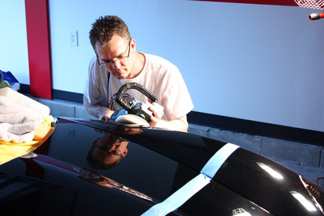 Cooperider hits the body panels with a buffer wheel and polish.