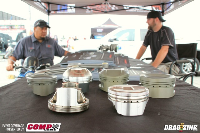 Wiseco has a display for the first time this year showcasing several different piston designs and coatings and their K-1 crank and connecting rods. I spoke with representative Victor Ellinger who ran off a list of racers that use their product, including Dewayne Mills, Steve Jackson, Brad Edwards and Team M&M. You can see the difference in the greenish hard anodized coating and the gold armor plating. They also offer a billet series piston for custom applications. Oscar Rodriguez from Precision Racing Development (PRD) and Jeff Cartain talk piston tech.