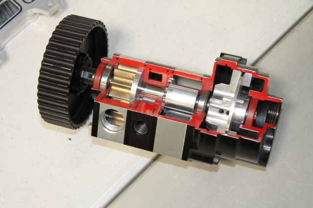 A cutaway of one of the company's pumps.  In the front is the oil pressure feed pump with a pressure regulator just behind it, the middle portion makes up the scavenge sections and on the rear is an air oil separator. 