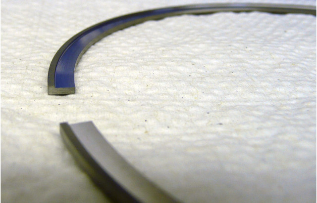 Our C33 stainless steel top ring in a .017 dykes configuration. Total Seal takes a standard 1/16” ring (.0625” thick) and then machines a .017” step from the inside of it to form a sideways “L” shape.