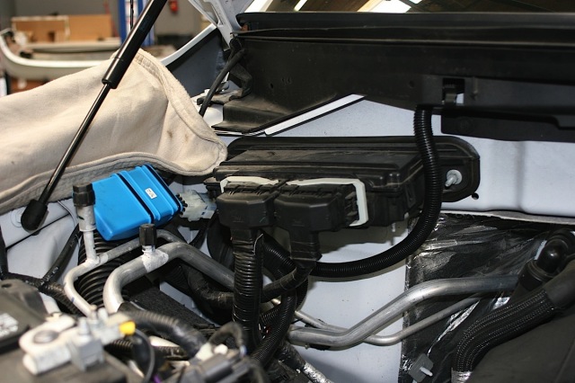 The wiring harness is placed, with its long leg routed through the cowling to the driver's side and down to the receiver.