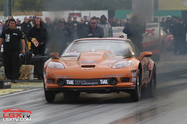 Twin exhaust plumes shoot from the fender turbo outlets on Mark Carlyle's Drag Radial Corvette.