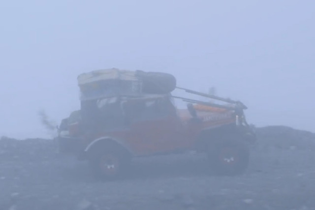 Almost a mile above sea level, Super Jeep crawled through fog with cliffs on either side of a narrow road.