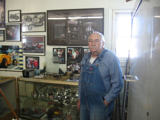 Ron standing alongside is 'brag board." Note photos of his old dragster