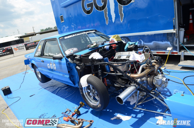 Maypearl, Texas native Leroy Nabors Jr. is making his NMCA debut here this weekend in his "Give God The Glory" Street Outlaw Mustang. Not only in this his series debut, but it's also his first foray into quarter-mile racing. Nabors' story is particularly unique in that he's only been racing a short time -- sharing with us that he's only been down a dragstrip in any type of vehicle less than 30 times. His motivation stemmed from his 20-year old son, who battles with Cystic Fibrosis and dreamed of going racing. So Nabors, with a fearless personality, bought a former grudge car, befriended esteemed tuner Patrick Barnhill, and went X275 racing. The car, in Street Outlaw trim, features a 402 cubic inch small block Chevrolet with Brodix 18-degree "X" heads and a Precision Pro Mod 88mm turbocharger. Nabors plans to follow the rest of the NMCA tour, along with some 15 additional events in X275. He and Barnhill discovered water in the intake manifold during a testing hit yesterday, and were busy checking things out and making repairs today in preparation for qualifying.