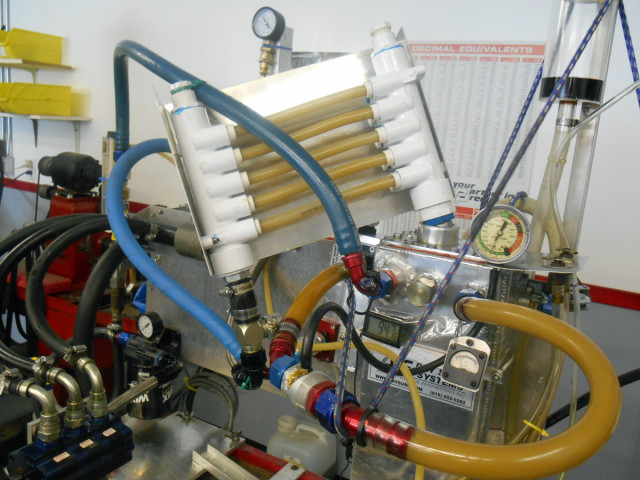 One of many test rigs Gary Armstrong built to test his theories about oiling systems. This machine uses a variable speed motor that runs up to 10,000 rpm for simulating air/oil separation. Shown is a special deaeration test rig that operates similar to the Coriolis effect.