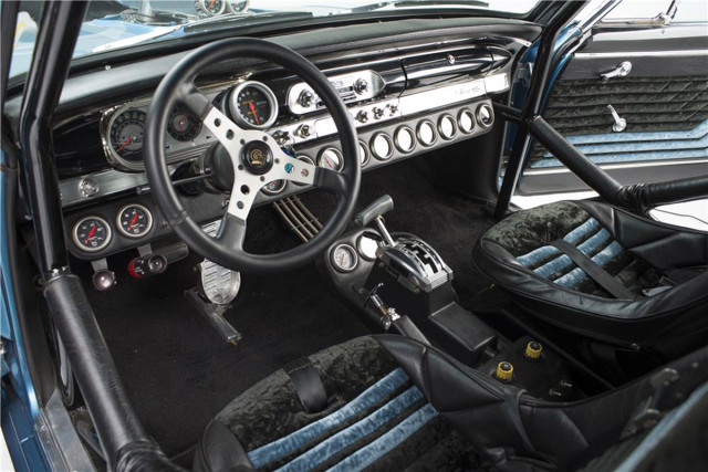 The interior screams fast. Two custom-built buckets are installed inside of a full roll cage. 