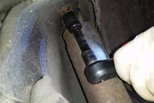 There are two bolts with 15mm/5/8 inch heads on the upper shock mounts. This is the rear one. 