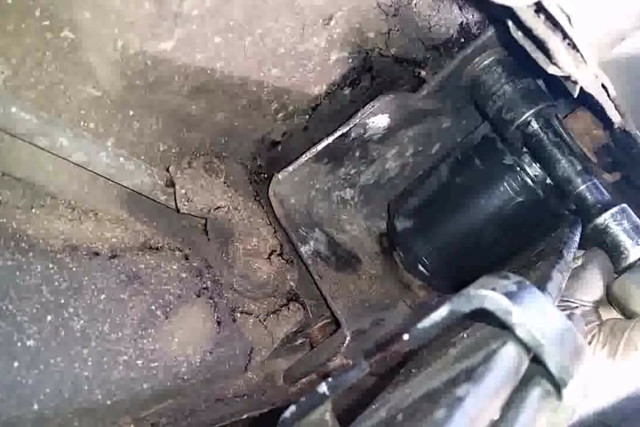 Raise the spring and bracket/pocket assembly into place and install the three bolts and torque them. 
