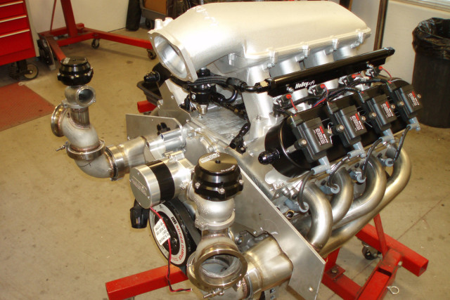 The assembled engine awaiting installation. This is one serious piece -- 1,000 miles of cruising the highway, and 7.70s at will on the dragstrip. 