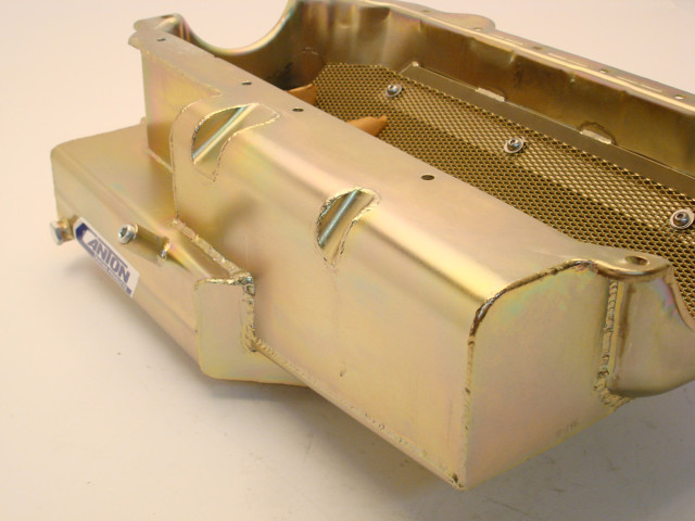 The "power pouches" or intends seen here on the side of the pan serve to reduce the parasitic power loss. While some aftermarket LS blocks allow for the use of features like these, the skirted design of the stock LS block means windage trays have to play the role of keeping excess oil off of the crank.