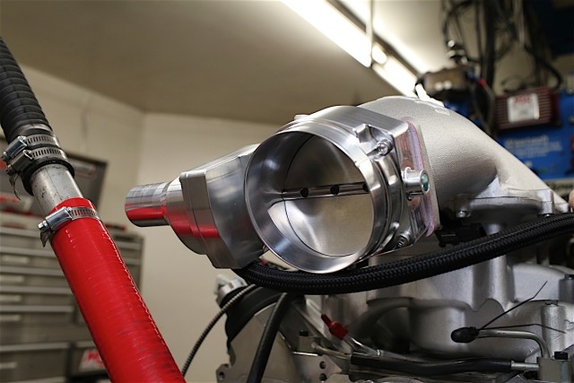 Although all the tests were done with a Nick Williams 102mm throttle body (PN. SD102MMEL), the stock intake is the only one among them with a port size that’s designed for the stock 92mm unit. While using a larger throttle body on a stock manifold can result in power gains in some situations, ideally you’d want the intake port size to match the size of the throttle body, as it did with the other intakes we tested, to prevent a potential bottleneck in airflow. That can often be accomplished by either port-matching the stock intake or simply swapping it out for a different intake which already has a port size that matches the aftermarket throttle body.