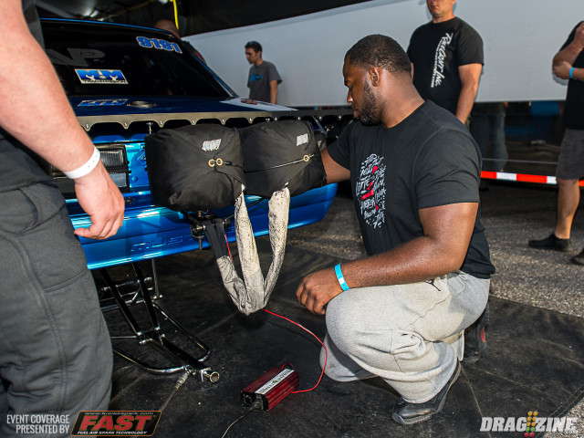 Fletcher Cox checks over his car, driven by Shawn Ayers in Radial vs the World, after a test hit. Cox's car is sporting a killer new stance and some other upgrades this weekend as the team searches for consistency.