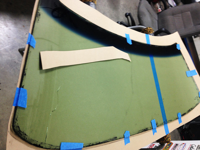 We began the windshield work by tracing the OEM glass onto our cardboard template, which we'd later transfer onto the polycarbonate.