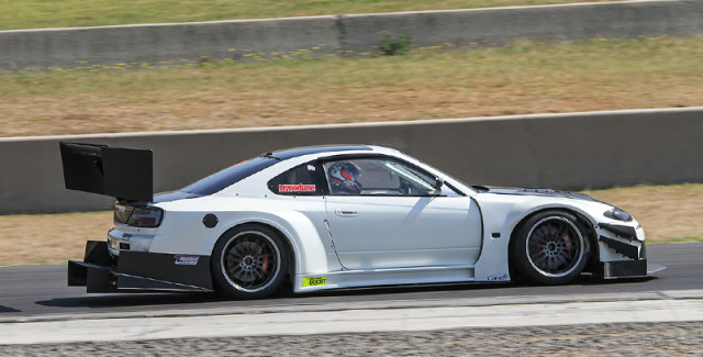 A massive Voltex wing and diffuser keep it planted at speed, but finding low-speed traction is still tough.