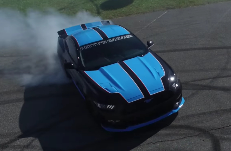 Richard Petty autographs the asphalt with his 727HP ’Stang