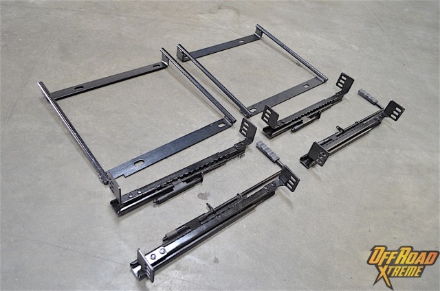 The smaller brackets are what come standard with the seat to allow it to slide. The larger square brackets are the adapter mounts for the XJ.