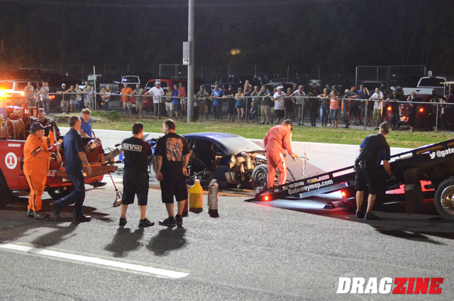 Father and son survey the damage to Terry Barkley's Camaro after a high-speed accident in St. Louis. Carl, Jr. has shattered the 1/8-mile Pro Extreme record in the very same car with a clocking of 231 mph.