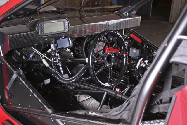 Ryan's office is all business. Everything needed to monitor the engine's vitals and control the car are neatly arranged and easily accessible. The all carbon fiber dash is pretty sweet too...