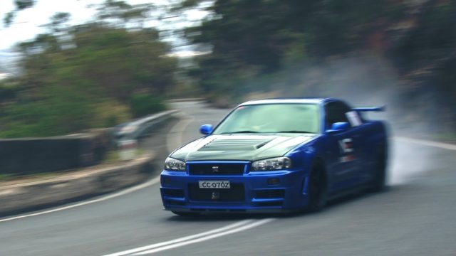 Bonham brakes hard in his Skyline as it belches gray smoke. 