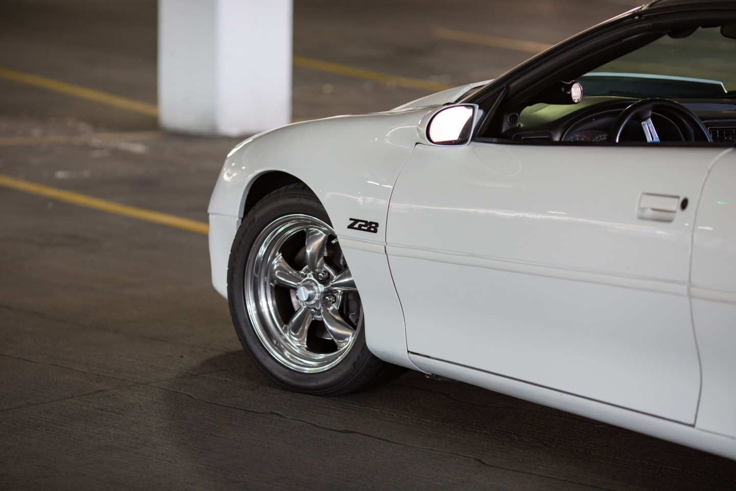 2002 Chevrolet Camaro front end lurks in a parking garage