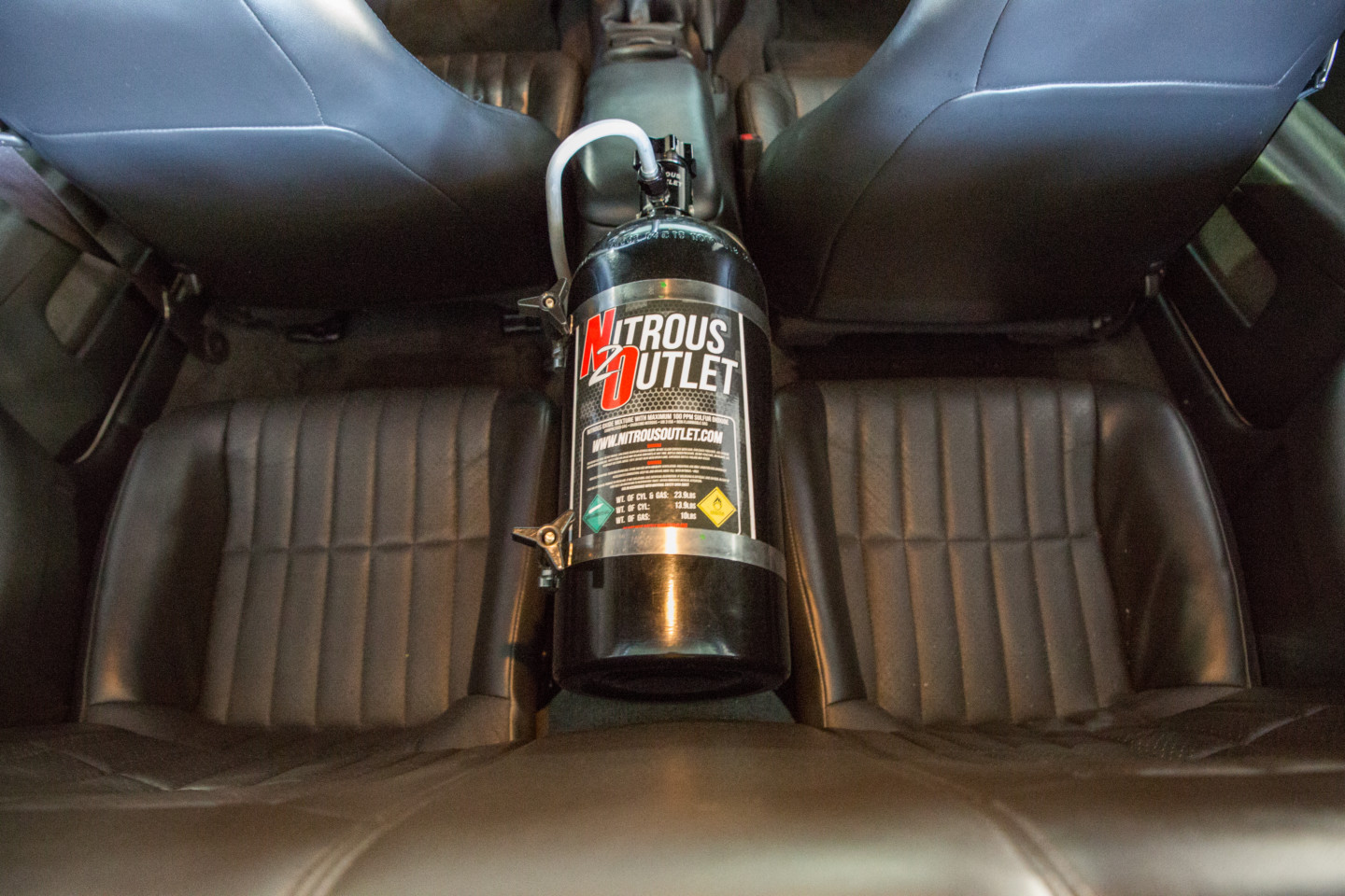 A nitrous bottle sits between the passenger rear seats