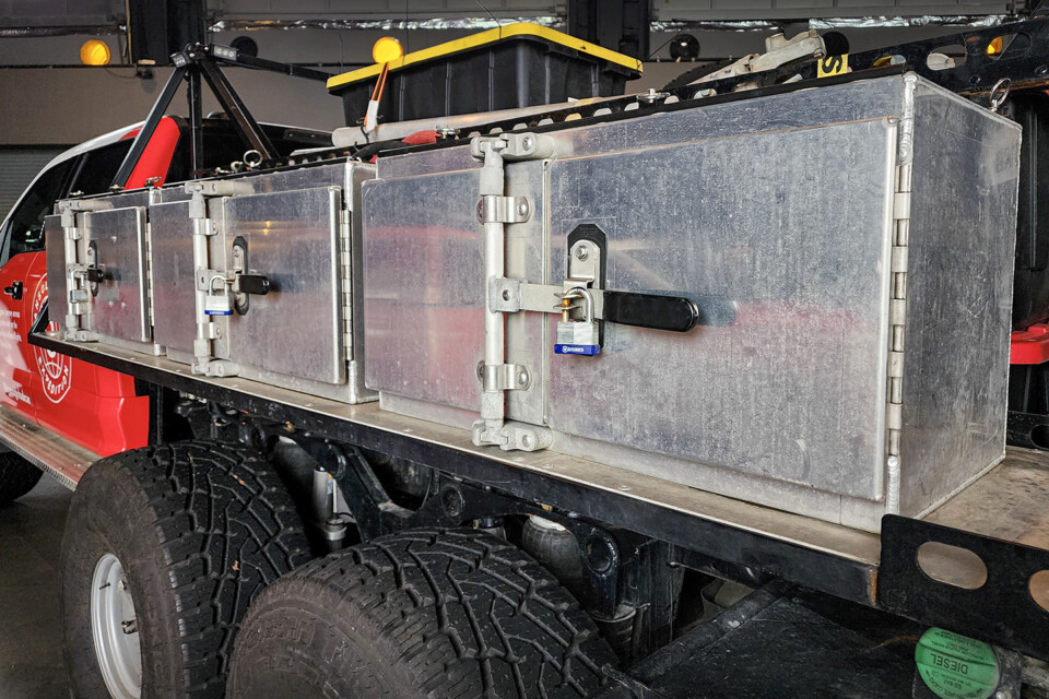 Several storage boxes are outfitted on the back of this AT44 6x6 truck
