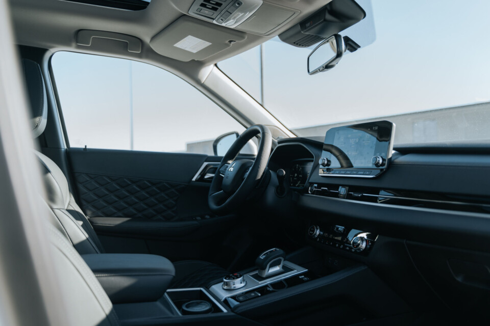 The interior of the 2024 Mitsubishi Outlander PHEV offers quilted accents, and matte and black colors throughout.