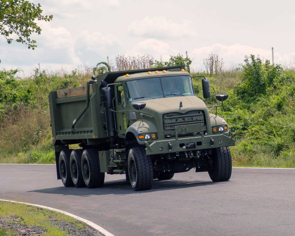 Another Load of Mack Defense Dump Trucks