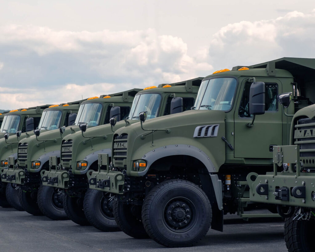 Another Load of Mack Defense Dump Trucks