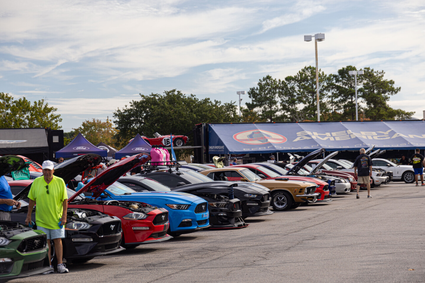 Mustangs lined up at Mustang Week Friday Car show in front of Shelby American Tent