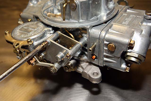 The first step in the conversion is to remove the manual choke plate which comes off by removing these three screws.