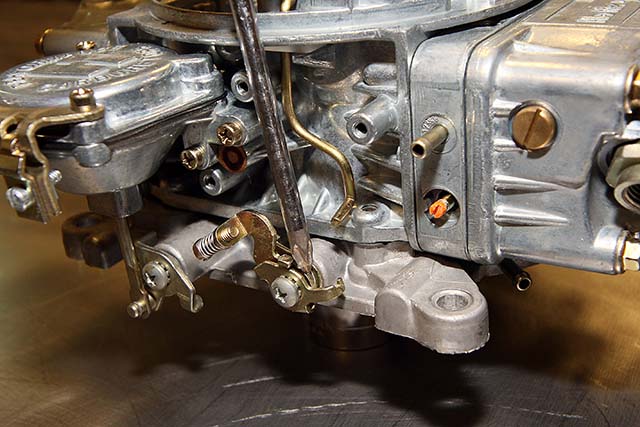 The fast idle lever assembly is held on with this screw. Remove the screw and the assembly, but save the screw, the wire spring and the smaller of the two levers for reuse.