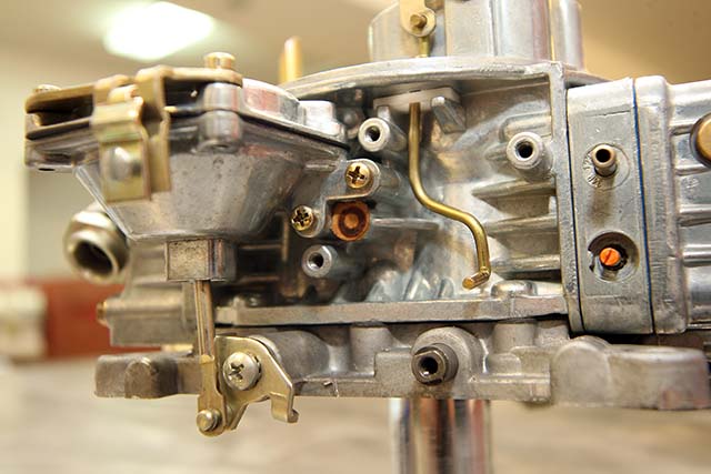 The last piece to be removed is the small gasket which you can see in this photo. Make sure the surface where it attached to the carburetor is clean and the air passage it covered is clear. You can blow compressed air through it, and the air should exit out the bottom of the carburetor. The kit will include a new gasket with a hole it it to allow air through. Ours had an adhesive backing. Install it in place of the old, solid gasket.