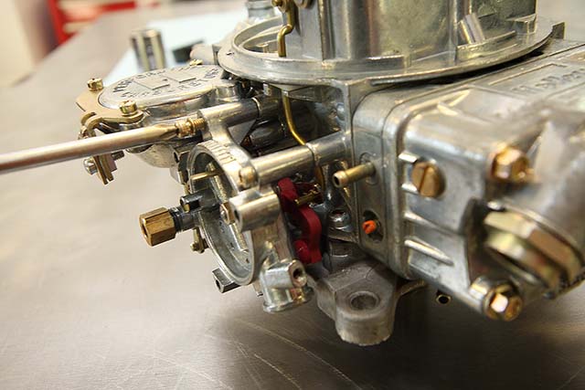 The choke housing is secured to the carburetor at the same three attachment points used for the manual choke plate. Our kit included new fasteners.
