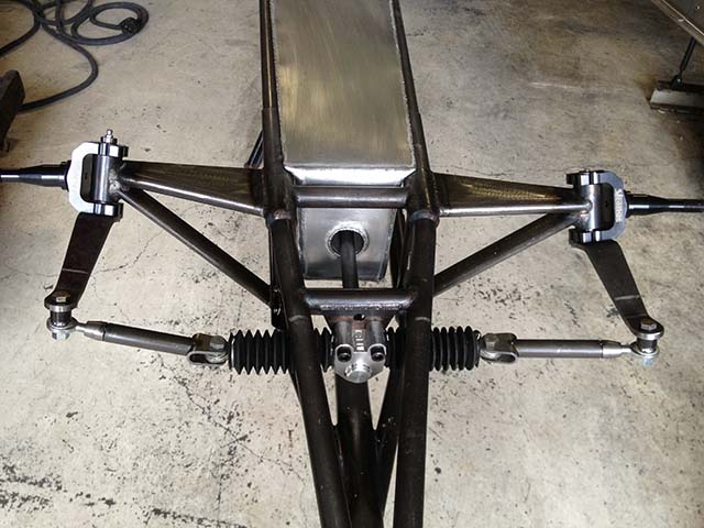 To maximize weight and balance factors, the steering box is located on the front side of the A-arms, which also allows more forward location of the fabricated fuel tank. Every tank is hand fabricated from sheet stock by Haase.