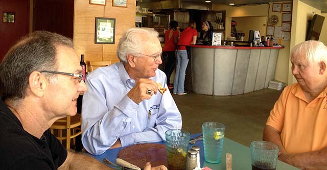 Discussion of innovative construction features in new Top Dragster being built for Hemi legend Joe Teuton, by chassis builder Chuck Haase over lunch. From left, Chuck Haase, Bob "Johnny Reb" Fulton, and Joe Teuton Sr.