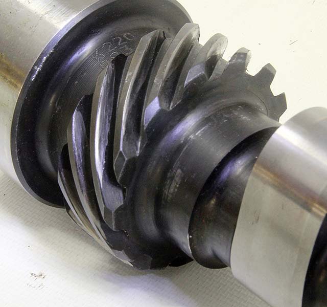 This is a steel Comp Cams mechanical roller cam for a big-block Chevy. While the gear on the cam appears to be iron, it is in fact a steel gear that has been parkerized for hardening. One way to tell this is a steel cam is the surface between the cam lobes is very smooth. This indicates a billet steel cam. We ran this cam with a normal iron gear and experienced significant wear in a very short period of dyno time. There is no fix for this other than replacing the cam.