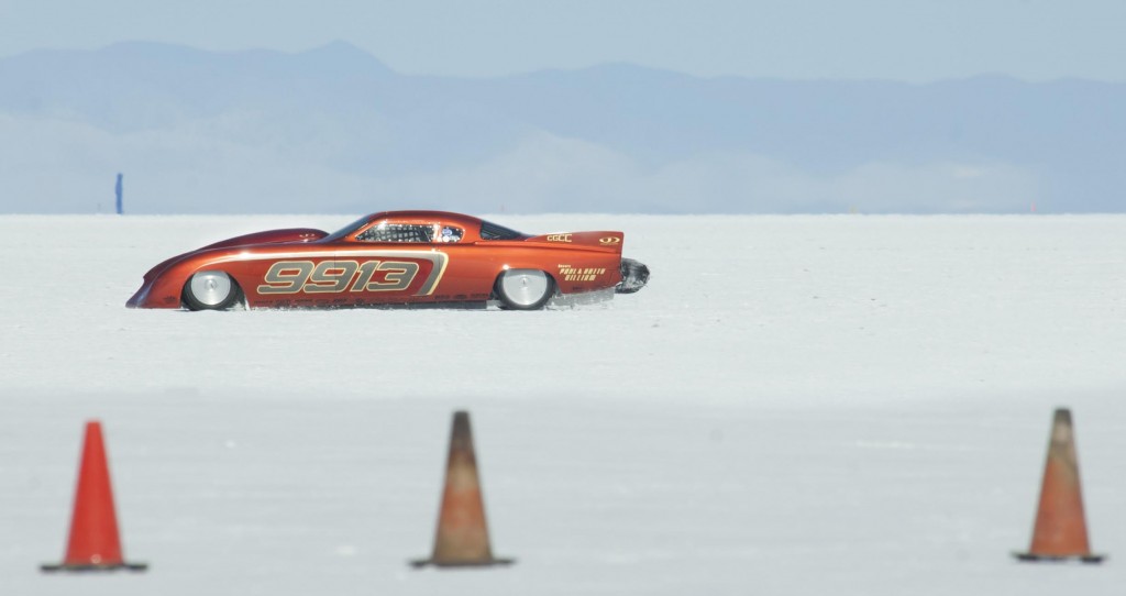 Bonneville Speed Week 2016Renown automotive designer Raymond Loewy had no idea the elegant 1950s Studebaker design would be embraced by the land speed racing world where his slippery bodies would carry drivers to Bonneville glory 53 years later.Competing in Class G Gas Competition Coupe, the neon root beer colored car is owned by "social directors" Betty and Paul Gilliam, but driven by Don Enriquez. Johnson’s Hot Rod Shop is responsible for the race car's design and build that carries a 369CID Automotive Specialists GM small block bullet under the hood.The car showed up on the starting line throughout the week, but only managed a top speed of 195MPH, down from its 2013 speed of 228MPH on the less than optimal salt racing surface. Most speed machines were conservative on their runs recognizing the thin 1-inch salt crust was only beginning to heal itself from two years of torrential wet weather thanks in a big way to the advocacy work of the Utah Alliance and Save the Salt.