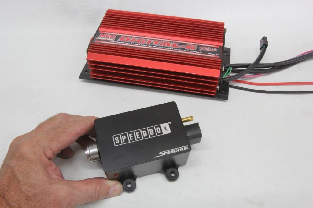 The SpeedBox is relatively compact with a footprint of 3.7 inches square at the mounts and just under 2.0 inches tall — shorter and narrower than this MSD Digital 6 box. The SpeedBox’s overall length is 5.13 inches, including the speedometer and electrical connections. The small brass connector is for the GPS antenna.