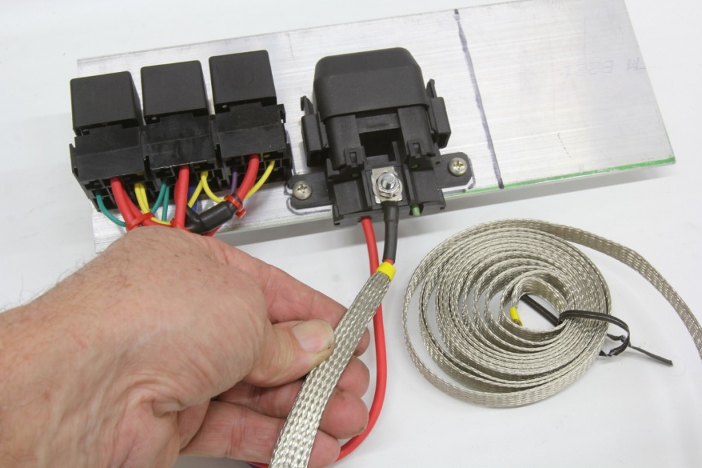 Another good shielding covering is made by TechFlex and called Flexo-Shield expandable sleeving. It is a high-performance EMI shielding sleeve that cuts easily with scissors and works to protect sensitive digital sensor cabling or in this case, covering the high current cables driving a high-amp electric fan relays.