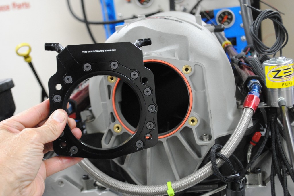 The boost-in-a-bottle portion of the equation was supplied by Zex in the form of their Perimeter Plate. The trick plate featured an insert (with o-ring) to size the opening for the desired throttle body. The plate was even labeled for proper orientation. 